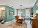 Inviting dining room with a wooden table, vintage decor, and a decorative display shelf at 3876 Timber Ridge Ct, Palm Harbor, FL 34685