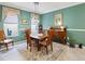 Cozy dining room featuring a wooden table set, vintage decor, and natural light from two windows at 3876 Timber Ridge Ct, Palm Harbor, FL 34685