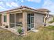 Exterior showcasing the screened lanai with seating and beautiful landscaping around the house at 3876 Timber Ridge Ct, Palm Harbor, FL 34685