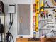 Close-up of a garage electric car charger and pegboard with tools for DIY projects at 3876 Timber Ridge Ct, Palm Harbor, FL 34685