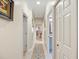 Hallway with white trim, a patterned rug and doors that lead to various rooms in the house at 3876 Timber Ridge Ct, Palm Harbor, FL 34685