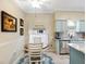 Bright kitchen and breakfast nook with matching blue island and kitchen cabinets at 3876 Timber Ridge Ct, Palm Harbor, FL 34685