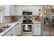Modern kitchen with stainless steel appliances, stylish countertops, and light blue cabinets at 3876 Timber Ridge Ct, Palm Harbor, FL 34685