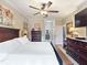 Bright main bedroom features a ceiling fan and an ensuite bathroom at 3876 Timber Ridge Ct, Palm Harbor, FL 34685