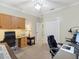 Bright office featuring built-in cabinets, desk, and ample lighting for a productive workspace at 3876 Timber Ridge Ct, Palm Harbor, FL 34685