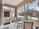 Screened patio features seating overlooking a scenic pond at 3876 Timber Ridge Ct, Palm Harbor, FL 34685