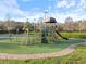 Well-equipped playground with slides, climbing structures, and artificial turf for safe play at 3876 Timber Ridge Ct, Palm Harbor, FL 34685
