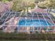 Overhead shot of a screened in pool area, featuring multiple chairs and tables for residents' enjoyment at 3876 Timber Ridge Ct, Palm Harbor, FL 34685