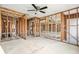 Spacious interior view featuring wood framing, concrete floor, and ceiling fan ready for customization at 39132 County Road 54 # 2060, Zephyrhills, FL 33542