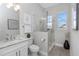 This bathroom features a glass enclosed shower, marble countertops, and a bright window at 4043 Rocky Shores Dr, Tampa, FL 33634