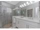 Bathroom with a dual sink vanity, shower with gray tile, and stone flooring in shower at 4043 Rocky Shores Dr, Tampa, FL 33634