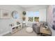 Bedroom with a soft chair, white curtains, and a window overlooking the neighborhood at 4043 Rocky Shores Dr, Tampa, FL 33634