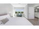 Bright bedroom featuring a couch by the window, light gray walls, and luxury vinyl plank flooring at 4043 Rocky Shores Dr, Tampa, FL 33634
