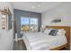 Bright bedroom featuring a queen bed, gray accent wall, and luxury vinyl plank flooring at 4043 Rocky Shores Dr, Tampa, FL 33634