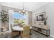 The dining room features a round table with seating for four and a large window letting in natural light at 4043 Rocky Shores Dr, Tampa, FL 33634