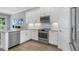 This contemporary kitchen features stainless steel appliances, a mosaic tile backsplash and light wood floors at 4043 Rocky Shores Dr, Tampa, FL 33634
