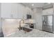 This contemporary kitchen features white cabinets, stainless steel appliances, and granite countertops at 4043 Rocky Shores Dr, Tampa, FL 33634