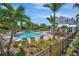 Community pool with lounge chairs surrounded by tropical plants and landscaping at 4043 Rocky Shores Dr, Tampa, FL 33634