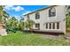 Exterior view of home with a wooden deck, lawn, mature landscaping and play set at 407 S West Shore Blvd, Tampa, FL 33609