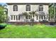 The backyard features a large deck with outdoor seating, palm trees and plenty of grass at 407 S West Shore Blvd, Tampa, FL 33609
