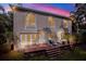 Backyard featuring a deck with furniture, a lawn, and the exterior of the house at dusk at 407 S West Shore Blvd, Tampa, FL 33609