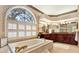 Bathroom featuring a large soaking tub beneath a large, arched window at 407 S West Shore Blvd, Tampa, FL 33609