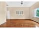 Empty bedroom featuring hardwood floors, neutral colors, and bright natural light at 407 S West Shore Blvd, Tampa, FL 33609