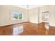 Empty bedroom featuring hardwood floors, neutral colors, and a view to the ensuite bathroom at 407 S West Shore Blvd, Tampa, FL 33609