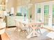 Charming dining area featuring a white table, seating for four, chandelier, and views to the outside at 407 S West Shore Blvd, Tampa, FL 33609