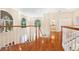 Foyer featuring hardwood floors, staircase with white banisters, and arched windows at 407 S West Shore Blvd, Tampa, FL 33609