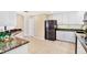 Kitchen featuring stainless steel appliances, granite countertops, and white cabinetry, adjacent to a breakfast area at 407 S West Shore Blvd, Tampa, FL 33609