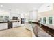 Bright kitchen featuring white cabinets, modern appliances, granite countertops, and tile flooring at 407 S West Shore Blvd, Tampa, FL 33609
