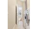 Tiled laundry room featuring newer washer and dryer units and door leading to interior at 407 S West Shore Blvd, Tampa, FL 33609