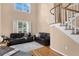 Cozy living area boasts high ceilings, large windows, hardwood floors, and a staircase with railing details at 407 S West Shore Blvd, Tampa, FL 33609