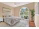 Spacious bedroom with hardwood floors, a ceiling fan, and a large arched window at 407 S West Shore Blvd, Tampa, FL 33609