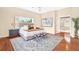 Spacious main bedroom featuring a tufted headboard, bright window, and ensuite bathroom access at 407 S West Shore Blvd, Tampa, FL 33609