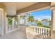 Outdoor balcony with elegant pillars and balustrade overlooking the beautiful waterfront at 436 St Andrews Dr, Belleair, FL 33756