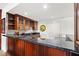 Wet bar area featuring wood cabinets, granite countertop and a wine rack at 436 St Andrews Dr, Belleair, FL 33756