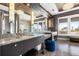 Bathroom featuring granite counters, double sinks, pendant lighting and a serene water view at 436 St Andrews Dr, Belleair, FL 33756