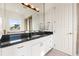 Bathroom featuring granite counters, double sinks, mirror and lighting at 436 St Andrews Dr, Belleair, FL 33756
