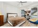 Well-lit bedroom featuring a large bed and a sliding glass door to a patio and storage shelving at 436 St Andrews Dr, Belleair, FL 33756