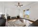 Bright bedroom with a ceiling fan, dark wood floors and access to a balcony with beautiful views at 436 St Andrews Dr, Belleair, FL 33756