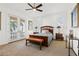 Bright bedroom with french doors and bench at 436 St Andrews Dr, Belleair, FL 33756