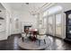 Elegant dining room featuring a fireplace, chandelier lighting, and large windows for an inviting atmosphere at 436 St Andrews Dr, Belleair, FL 33756