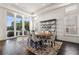Bright dining area with modern lighting, floor-to-ceiling windows, and sleek shelving against dark wood floors at 436 St Andrews Dr, Belleair, FL 33756