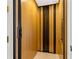 Residential elevator for easy access, featuring wooden paneling and safety features at 436 St Andrews Dr, Belleair, FL 33756