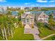 Beautiful waterfront home with lush landscaping, a circular driveway, and stunning curb appeal at 436 St Andrews Dr, Belleair, FL 33756