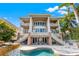 Grand home with a pool, waterfall feature, outdoor seating and balconies at 436 St Andrews Dr, Belleair, FL 33756