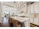 Open-concept kitchen with white cabinetry, a large center island, and pendant lighting at 436 St Andrews Dr, Belleair, FL 33756