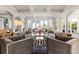 Sophisticated living room with high ceilings, arched doorways, and large windows with water views at 436 St Andrews Dr, Belleair, FL 33756